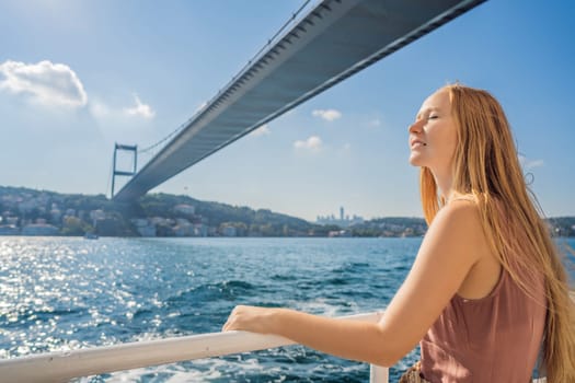 Happy woman enjoying the sea from ferry boat crossing Bosphorus in Istanbul. Summer trip to Istanbul.