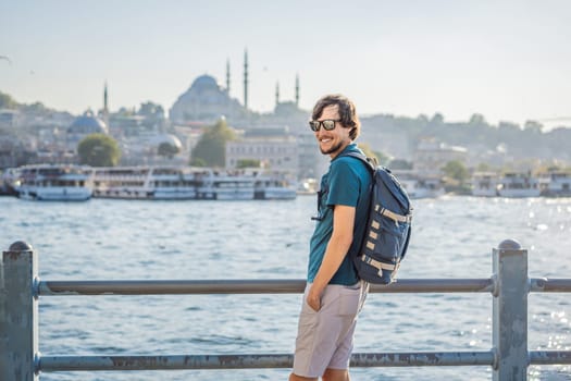 Young man traveler in pinc dress enjoying great view of the Bosphorus and lots of seagulls in Istanbul.