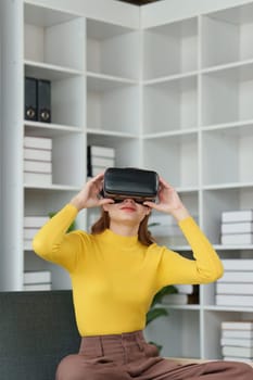 Attractive Asian woman resting comfortable living room and using AR glasses, Relax, Sofa, Lifestyle, Virtual Reality Headset.