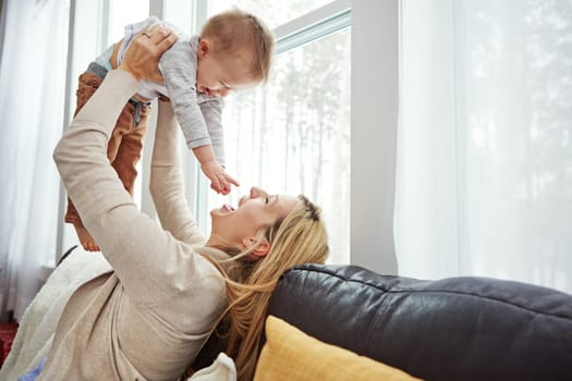 Motherhood taught me the true meaning of love and patience. a happy young mother playing with her baby boy at home