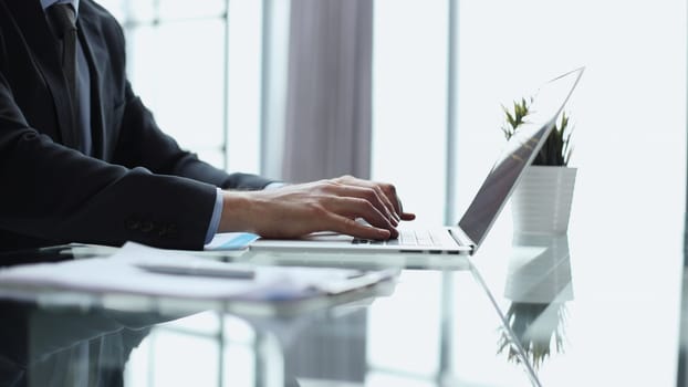 Close-up of male hands typing laptop keyboard. man using laptop