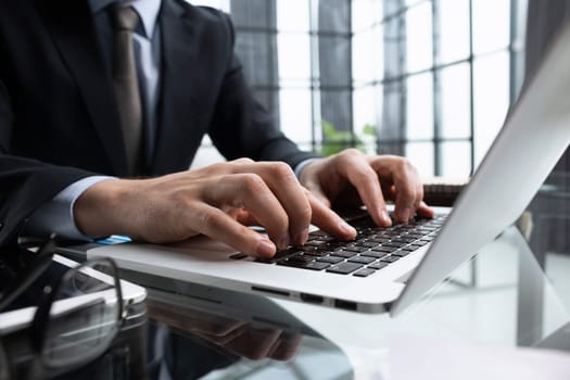 Close-up of male hands typing laptop keyboard. man using laptop