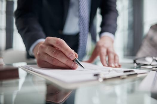 man hands with pen writing on notebook in the office.learning, education and work