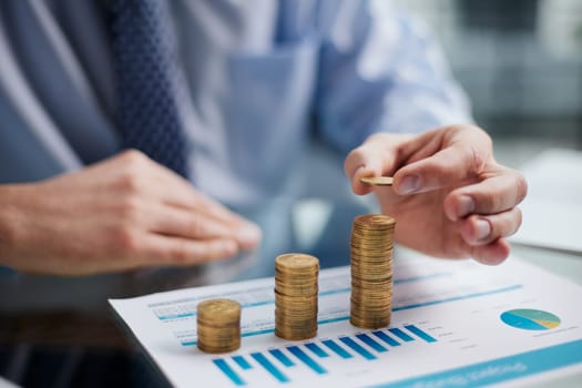 Business, Money, Finance, Secure and Saving Concept. Close up of man hand holding and put a coin to stack of coins table.