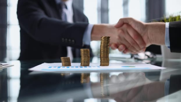 Real estate broker agent Shake hands after customer signing contract document for ownership realty purchase in the office, Business concept and signing contract