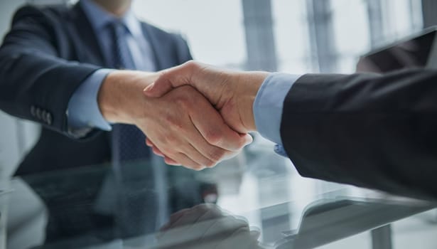 Real estate broker agent Shake hands after customer signing contract document for ownership realty purchase in the office, Business concept and signing contract