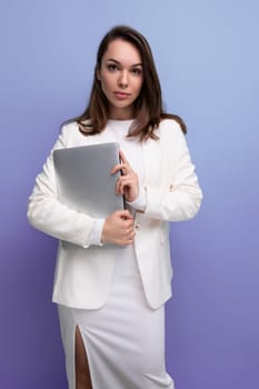 successful brunette business woman in white dress with pc.