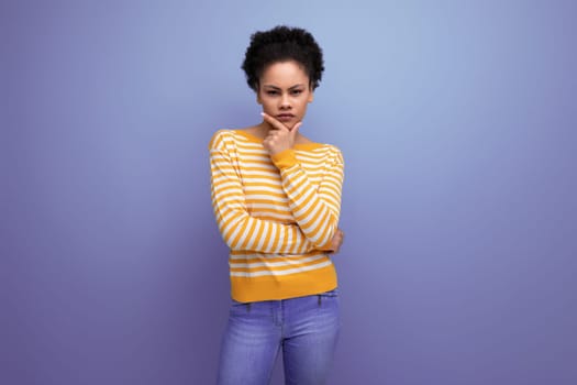 model pensive latina young lady with afro hair on studio background.