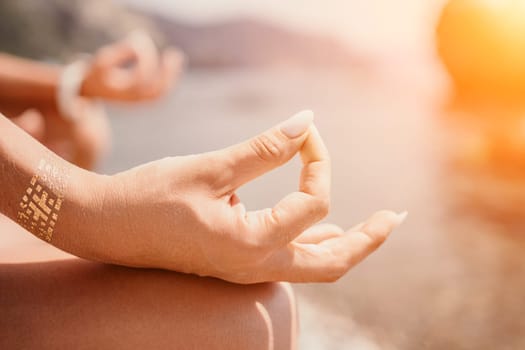 Woman sea yoga. Back view of free calm happy satisfied woman with long hair standing on top rock with yoga position against of sky by the sea. Healthy lifestyle outdoors in nature, fitness concept.