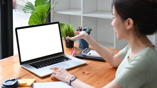 Young Asian woman watching webinar with computer laptop.