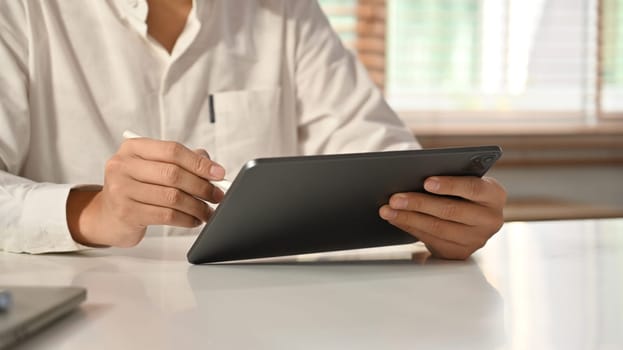 Cropped image of businessman using digital tablet. E-commerce business and Technology.