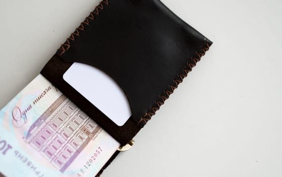 Ukrainian hryvnia money in leather money clip, wallet. Ukraine money on white background with. Currency of Ukraine. Accessories. Money, financess, economy, saving