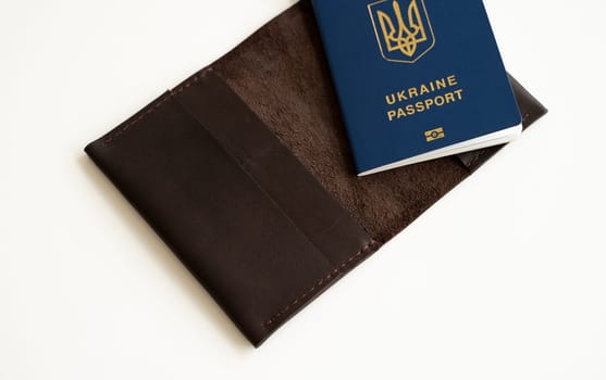 Ukrainian passport with a leather cover on a white background, selective focus. Inscription in Ukrainian Ukraine Passport