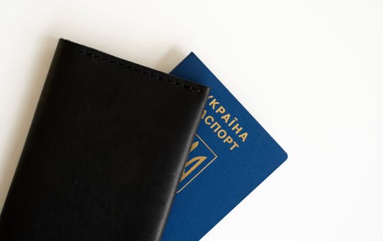 Ukrainian passport with a leather cover on a white background