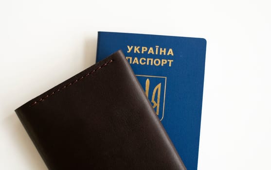 Ukrainian passport with a leather cover on a white background, selective focus. Inscription in Ukrainian Ukraine Passport