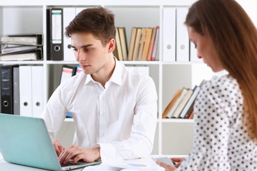 Group of people deliberate on problem with laptop pad closeup. White collar check money papers stock exchange market earnings list partnership agreement idea discussion startup concept