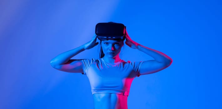 Young woman using the VR goggles and communicating with friends in metaverse. Future technology concept