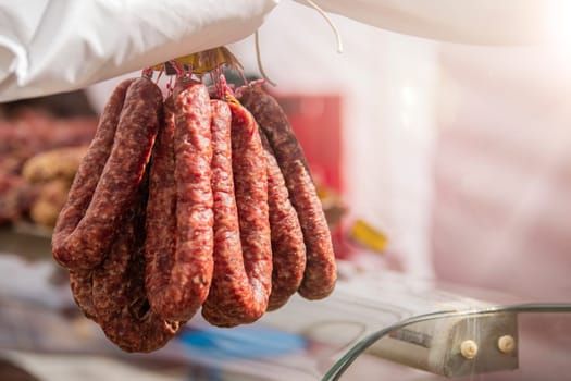 Fresh pork sausage rings lie on the counter of the meat market. Smoked meat products handmade. Buying food from meat. High quality photo