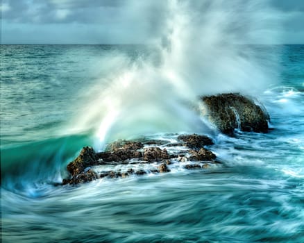 Ocean waves crashing on rocks, Dominican Republic.  Image taken early in the morning.