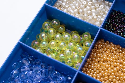 Colorful beads in containers close up, handicrafts, macrophoto