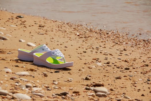 white sandals on the beach. Beach fashion. Copy space