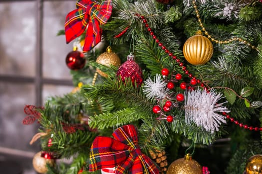 Christmas and New Year Decoration. Baubles hanging on Christmas Tree. Xmas holiday background with garlands, tinsel, ball.