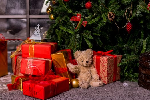 gifts under the Christmas tree, toy bear and boxes, the concept of a cozy home new year