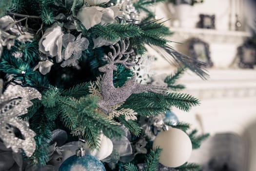 Christmas tree with blue and white toys in the interior.Christmas card with white and blue decor