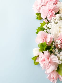 Close up photo of a bouquet of pink and white carnations isolated on a white background. With empty space for text or inscription. For postcard, advertisement or website.