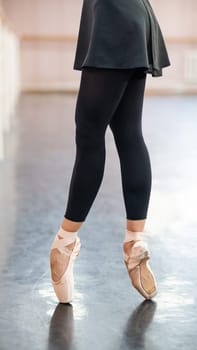 Close-up but ballerinas in pointe shoes in a dance class