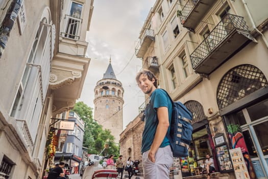 Portrait of man tourist with view of Galata tower in Beyoglu, Istanbul, Turkey. Turkiye.