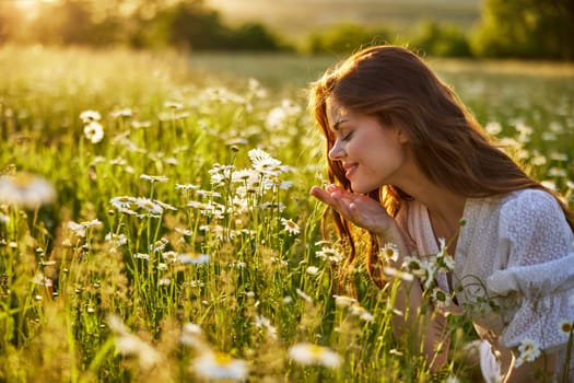 portrait of a beautiful, happy woman in a chamomile field, smelling flowers and enjoying nature. High quality photo