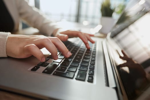 Businessman working at a home office uses a close-up keyboard,