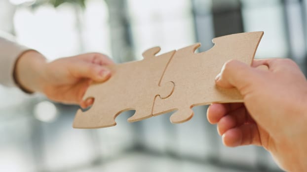 close up of business people connecting couple puzzle jigsaw