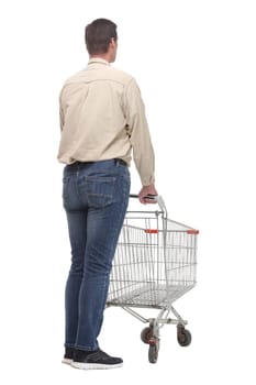 Back view of person pushing a shopping cart in car park, isolated over white background