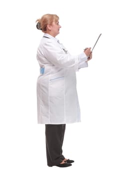 Side view portrait of experienced female physician writing patients report and looking away