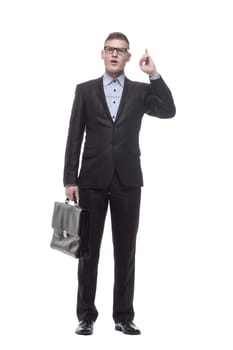in full growth. smiling young businessman with a leather briefcase. isolated on a white background.