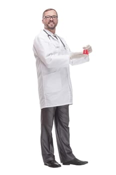 smiling doctor with a laboratory flask in his hands . isolated on a white background.