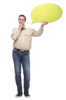 Cheerful young handsome caucasian man thinking and looking at empty white speech bubble isolated on white background