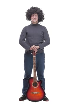in full growth. curly-haired cheerful man with a guitar. isolated on a white background.