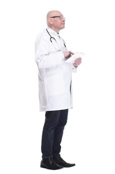 side view. doctor with a digital tablet looking at a white screen. isolated on a white background.