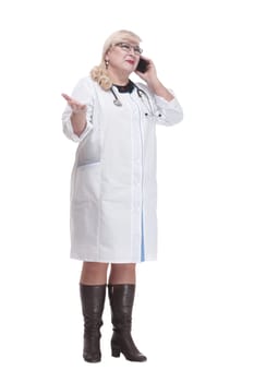 in full growth. attending doctor using her smartphone. isolated on a white background.