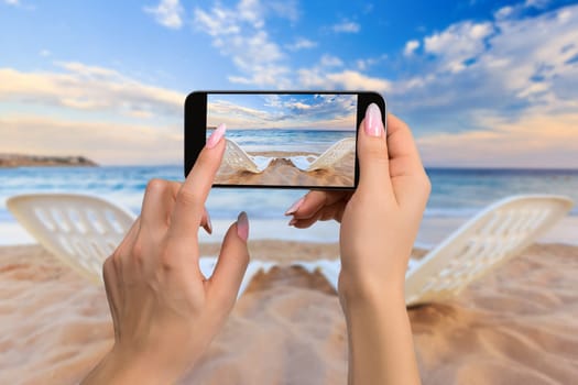 Landscape of Two Lonely beachchairs on the sand near sea in the morning at a perfect beach in Egypt. Photographing travel concept - woman takes picture of two beach chairs on the sand near sea and colorful sky