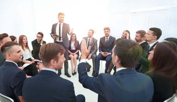 skilled coach asks questions to the participants of the training. photo with copy space