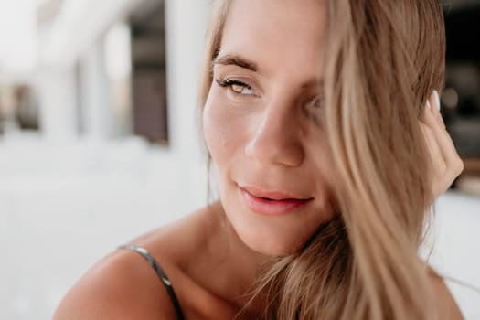 Happy woman portrait in cafe. Boho chic fashion style. Outdoor photo of young happy woman with long hair, sunny weather outdoors sitting in modern cafe