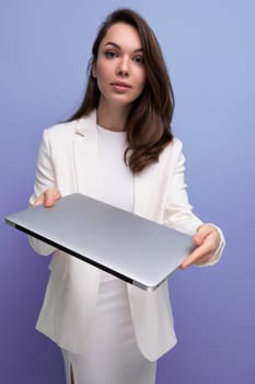 successful brunette business woman in white dress with pc.