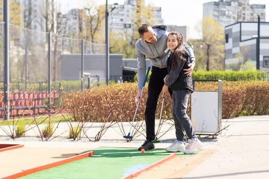 Mini-golf ball on artificial grass. Summer season game.