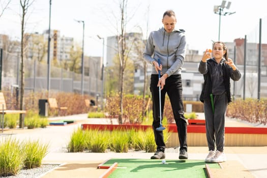 Mini-golf ball on artificial grass. Summer season game.