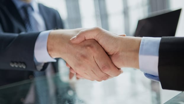 Real estate broker agent Shake hands after customer signing contract document for ownership realty purchase in the office, Business concept and signing contract