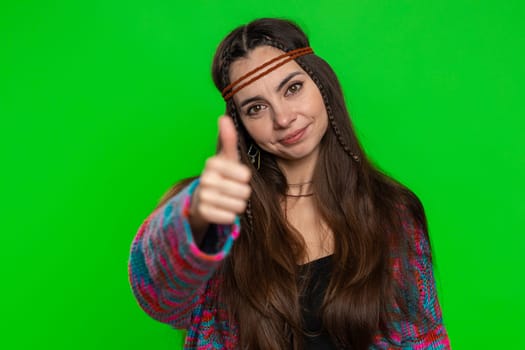 Like. Young woman raises thumbs up agrees with something or gives positive reply recommends advertisement likes good successful idea. Hippie girl isolated alone on chroma key background, green screen